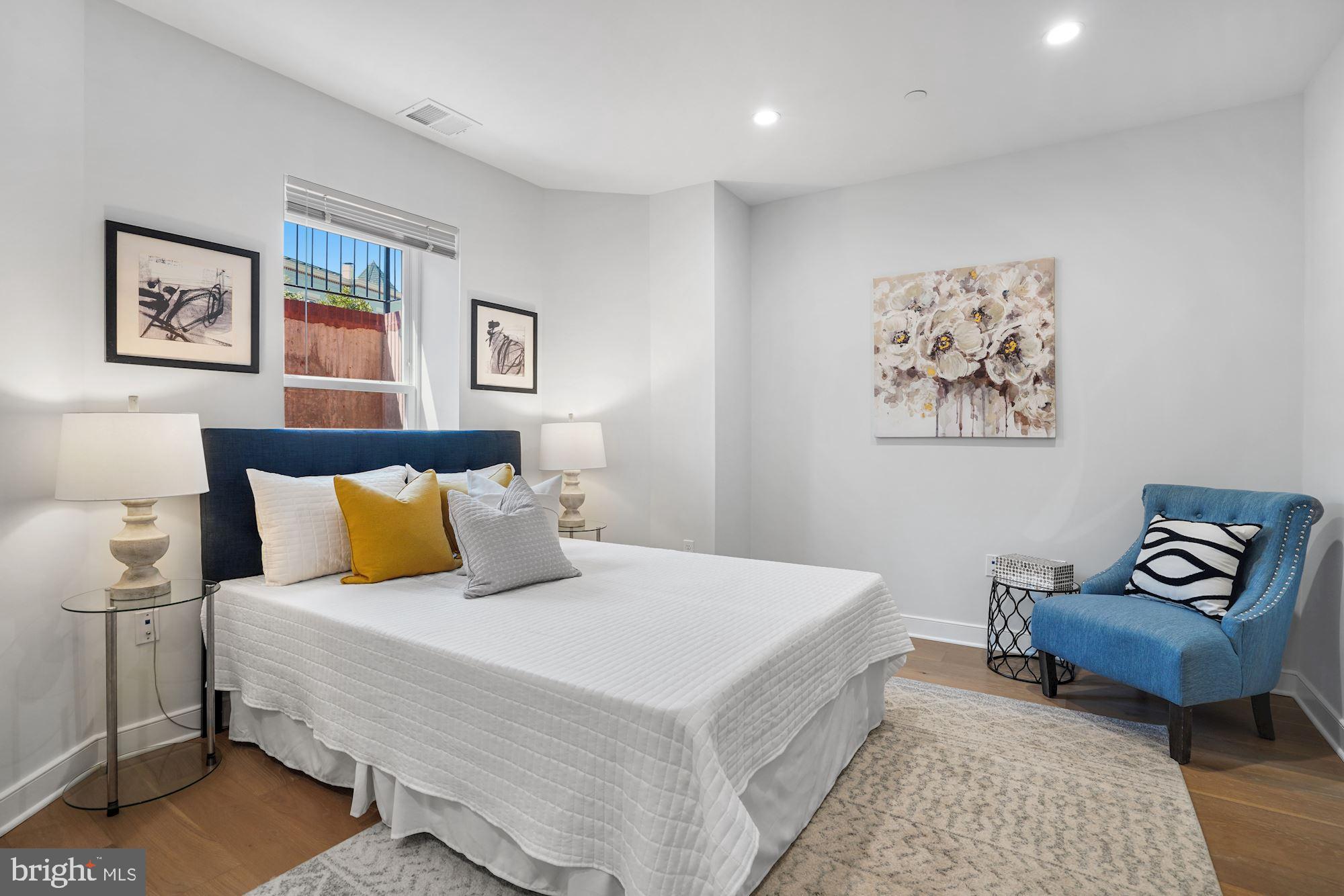 1021 Spring Road Northwest, Unit 1 Washington, DC 20010 - Photo 9 of 27 a bedroom with a bed and a couch