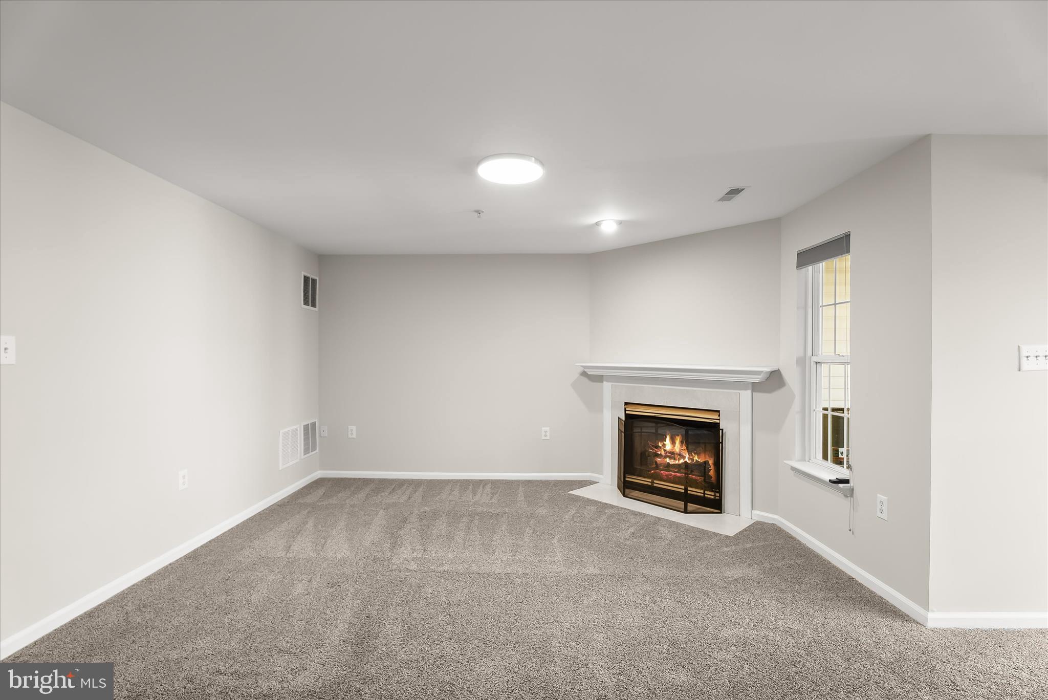 2631 Cameron Way Frederick, MD 21701 - Photo 56 of 86 a view of an empty room with a fireplace and a window