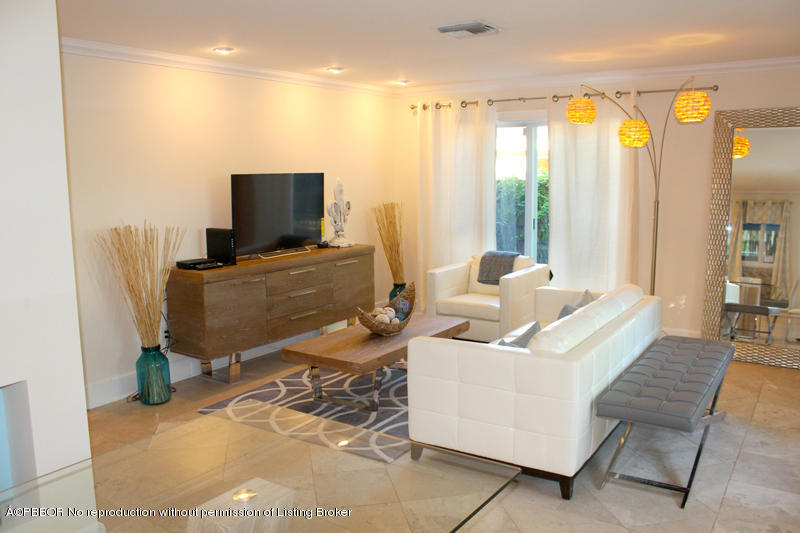 825 Sunset Road West Palm Beach, FL 33401 - Photo 3 of 12 a living room with furniture and a flat screen tv