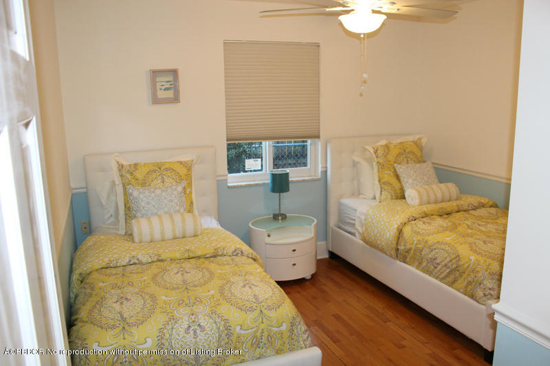 825 Sunset Road West Palm Beach, FL 33401 - Photo 9 of 12 a bedroom with a bed and wooden floor