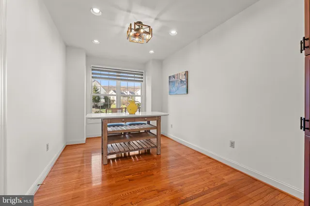 a view of a workspace with wooden floor and a window