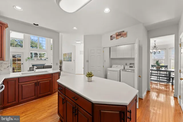 a kitchen with a sink a stove and chairs