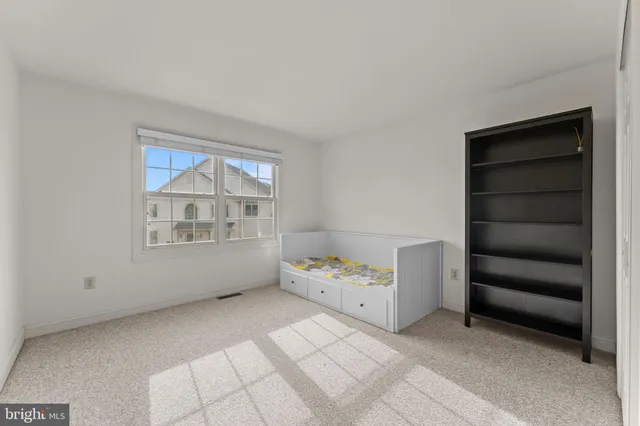 a room with a bed and a window