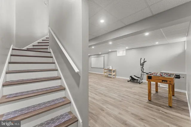 a view of a room with furniture and wooden floor