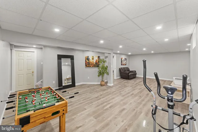 a living room with furniture a table and wooden floor