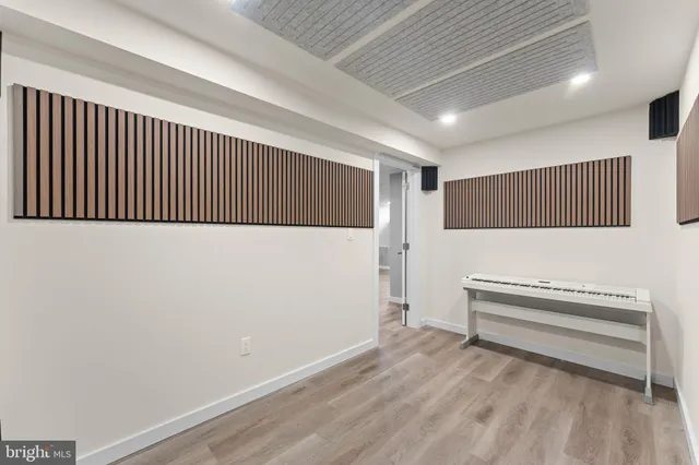 a hallway with stairs and a wooden floor