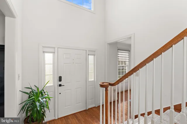 a view of staircase with railing and a potted plant
