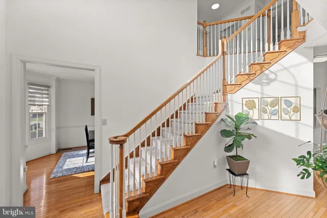 a view of entryway and hall with wooden floor