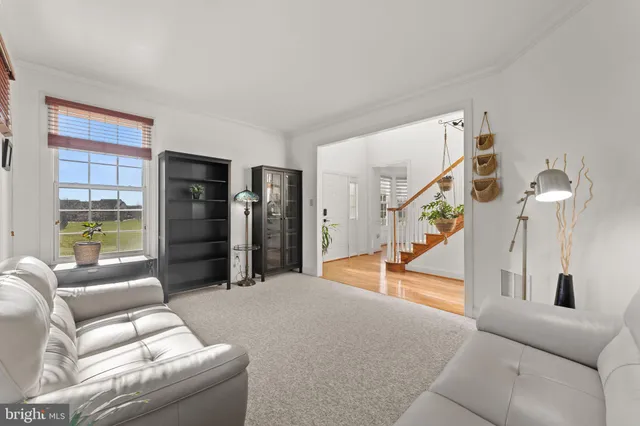 a living room with furniture and a floor to ceiling window