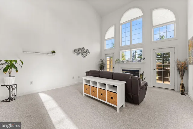 a room with a bed and a potted plant on the dresser