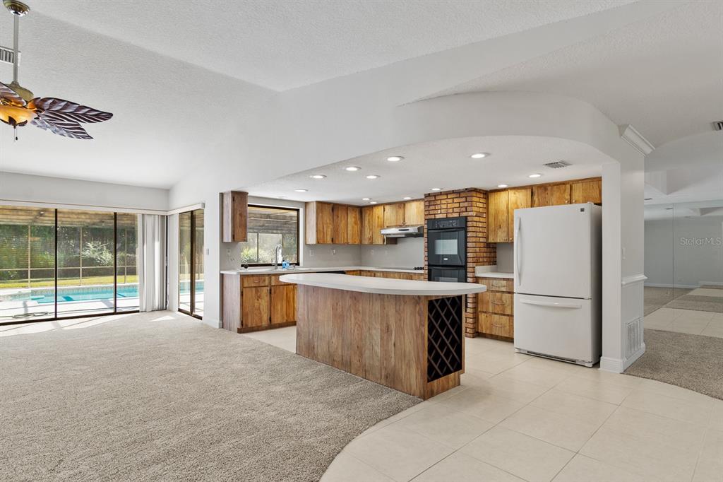 10206 Lakeview Drive New Port Richey, FL 34654 - Photo 7 of 53 a open kitchen with a sink and refrigerator