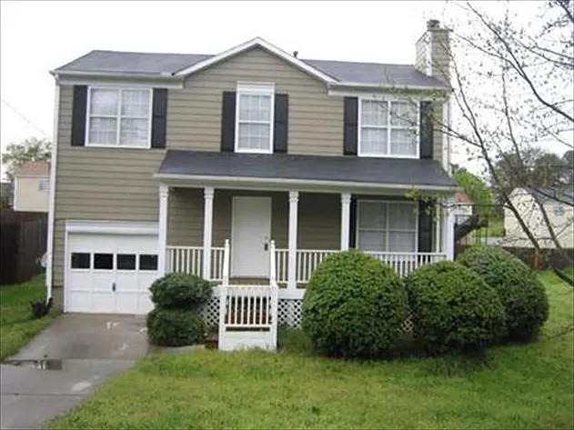 6118 Marbut Road Lithonia, GA 30058 - Photo 1 of 1 a front view of a house with garden