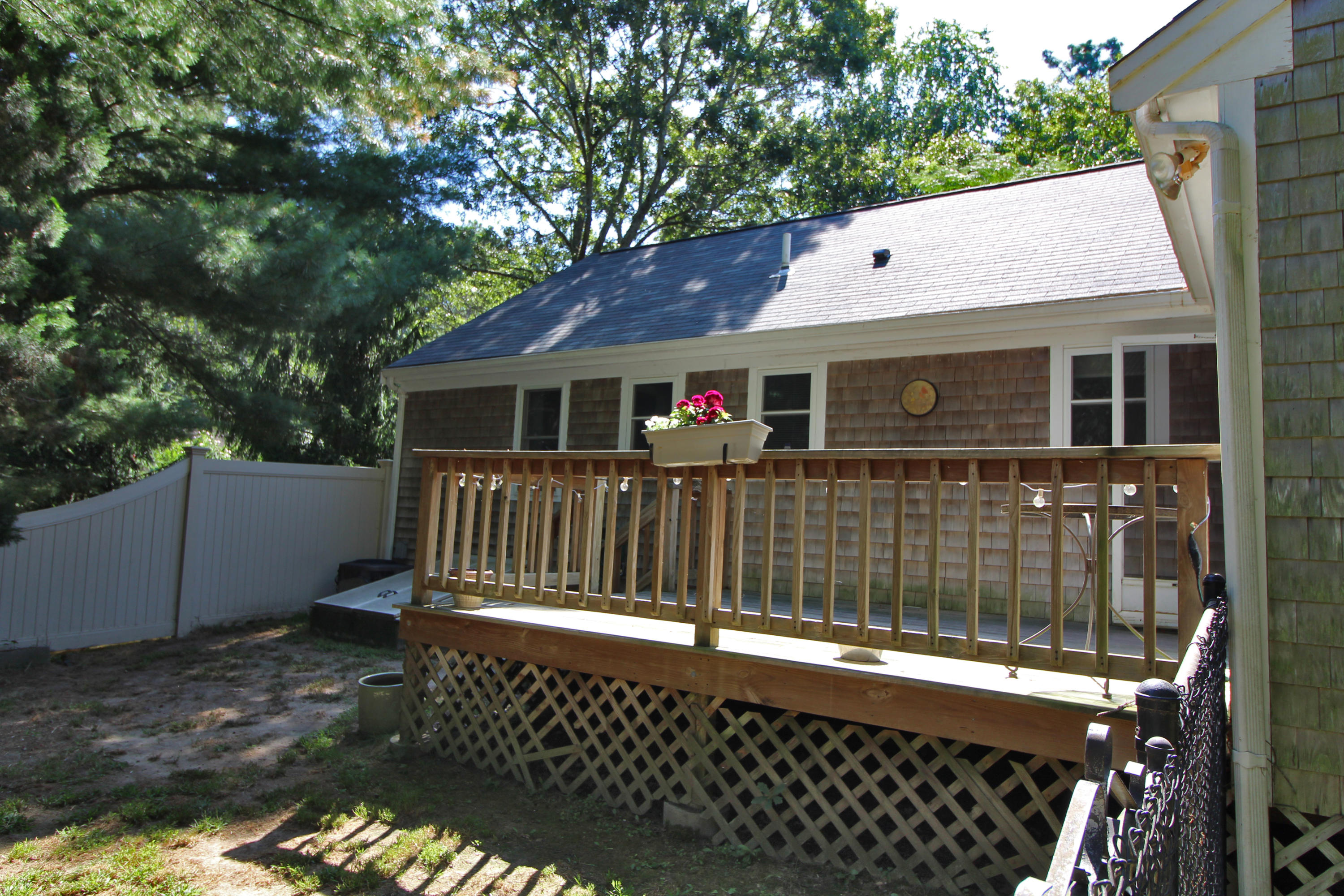 185 Sandy Valley Road Marstons Mills, MA 02648 - Photo 8 of 35 a view of a house with a small yard and wooden fence