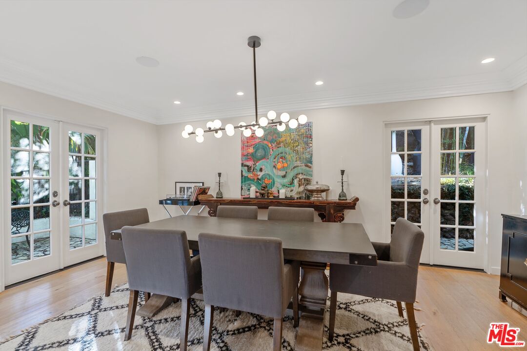 1643 Queens Road Los Angeles, CA 90069 - Photo 12 of 44 a dining room filled chandelier and wooden floor