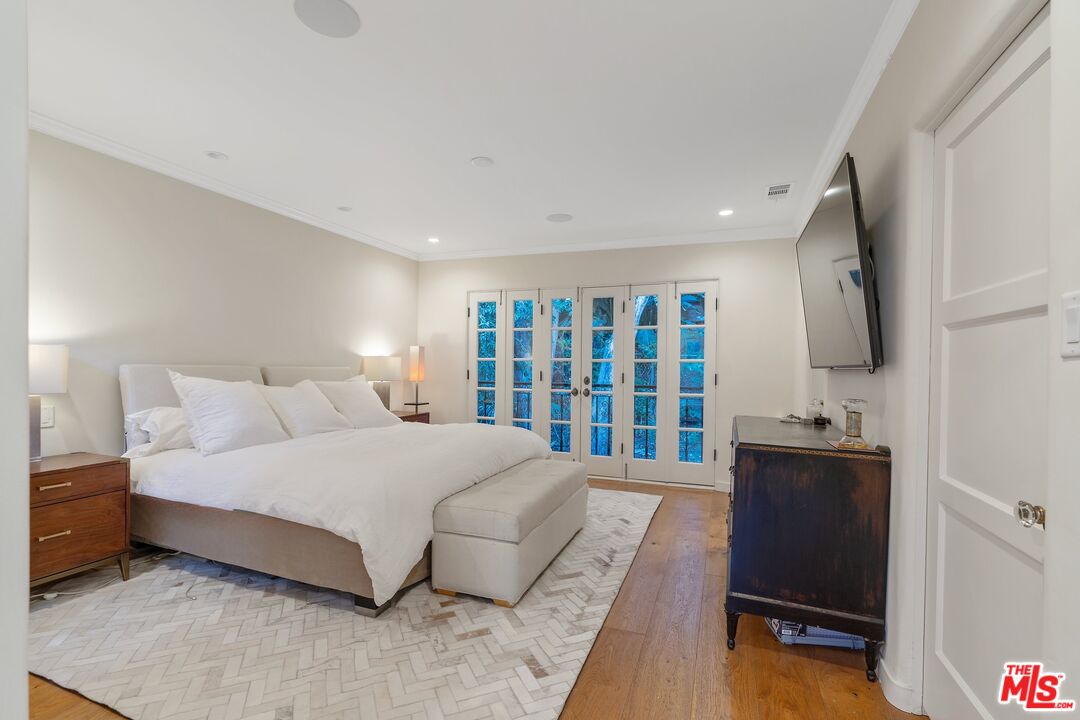 1643 Queens Road Los Angeles, CA 90069 - Photo 23 of 44 a bedroom with a large bed and a flat tv screen on dresser