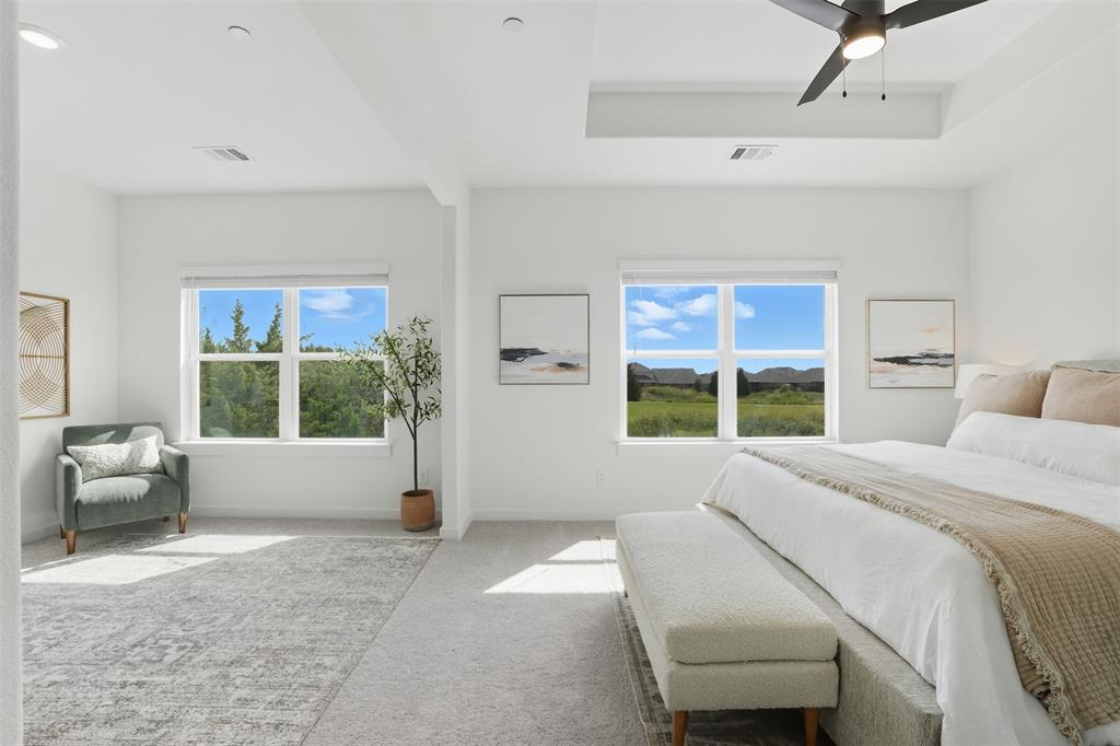 1614 Governors Boulevard Heath, TX 75126 - Photo 21 of 37 a bedroom with a large bed and a large window