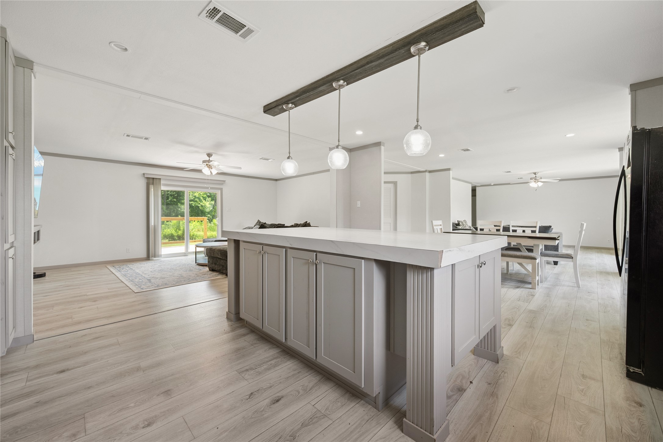 3006 County Road 2068 Hull, TX 77564 - Photo 11 of 27 a kitchen with stainless steel appliances kitchen island a white cabinets and a wooden floor
