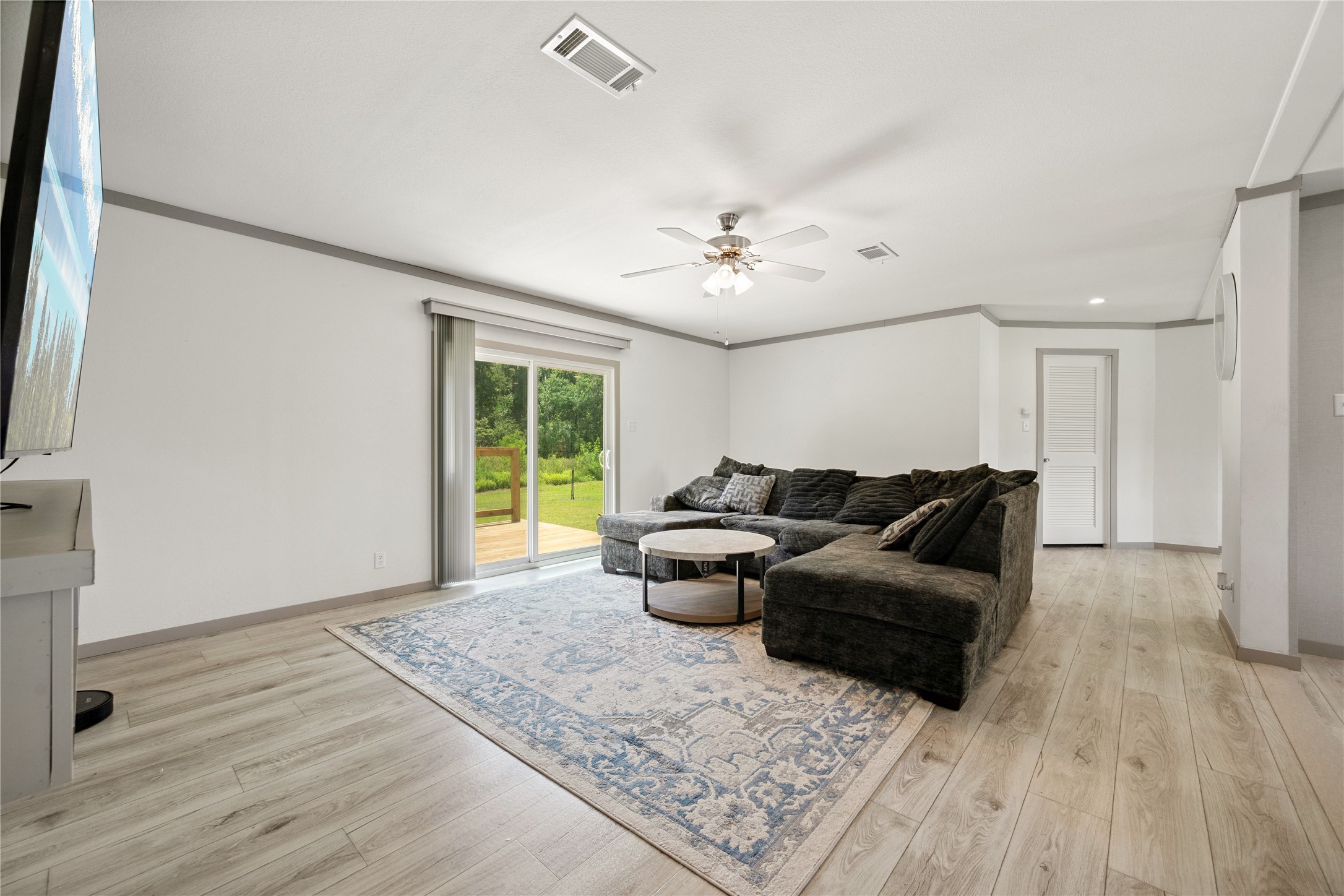3006 County Road 2068 Hull, TX 77564 - Photo 12 of 27 a living room with furniture and a chandelier