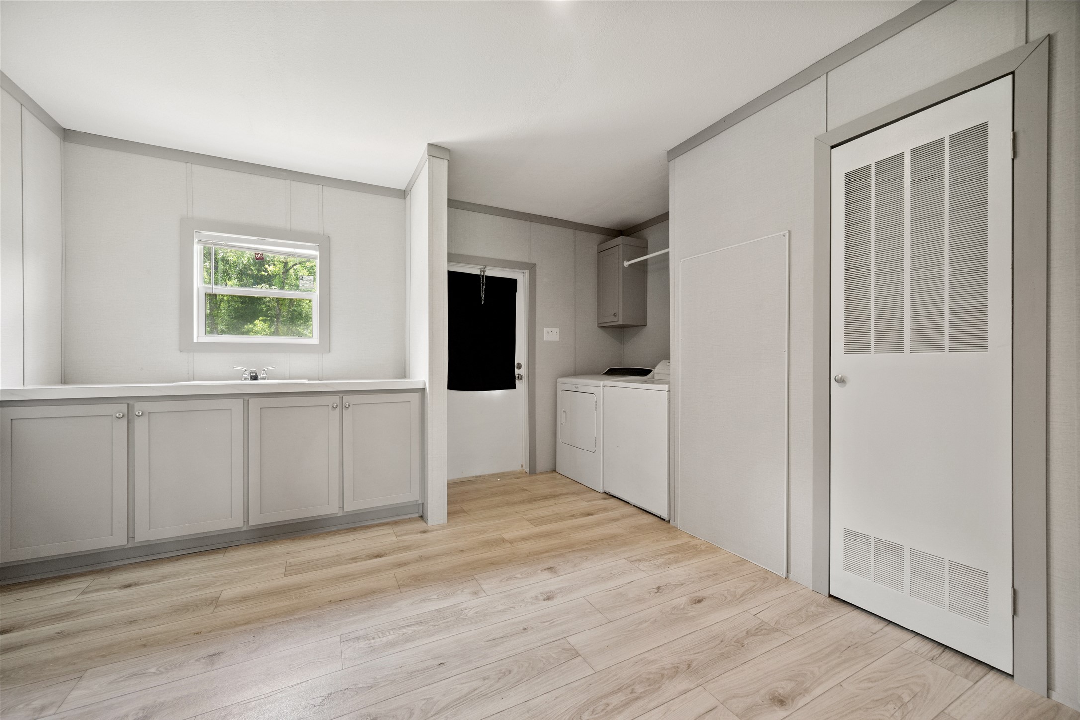 3006 County Road 2068 Hull, TX 77564 - Photo 17 of 27 a view of a kitchen with wooden floor and electronic appliances