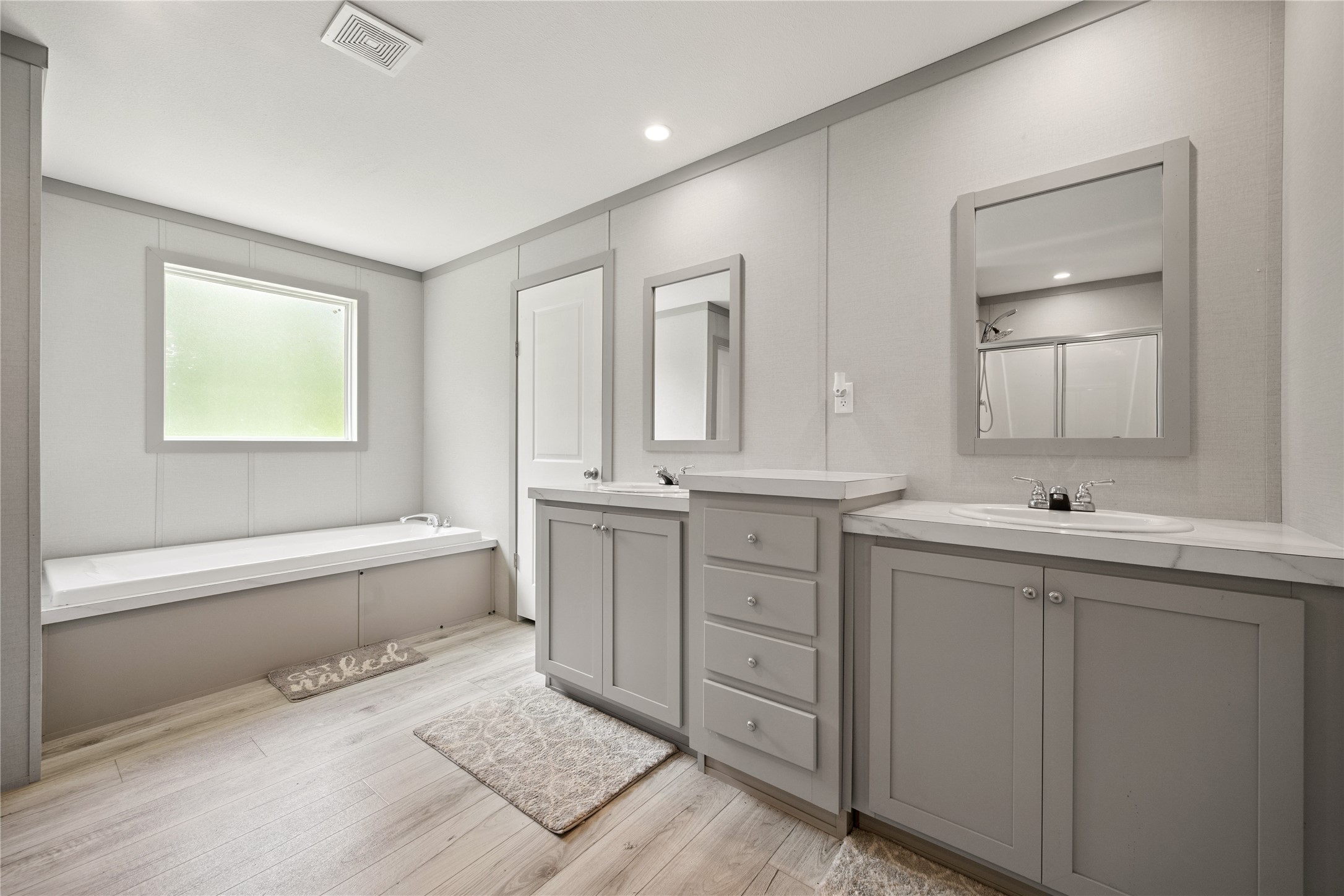 3006 County Road 2068 Hull, TX 77564 - Photo 19 of 27 a bathroom with a tub sink and mirror