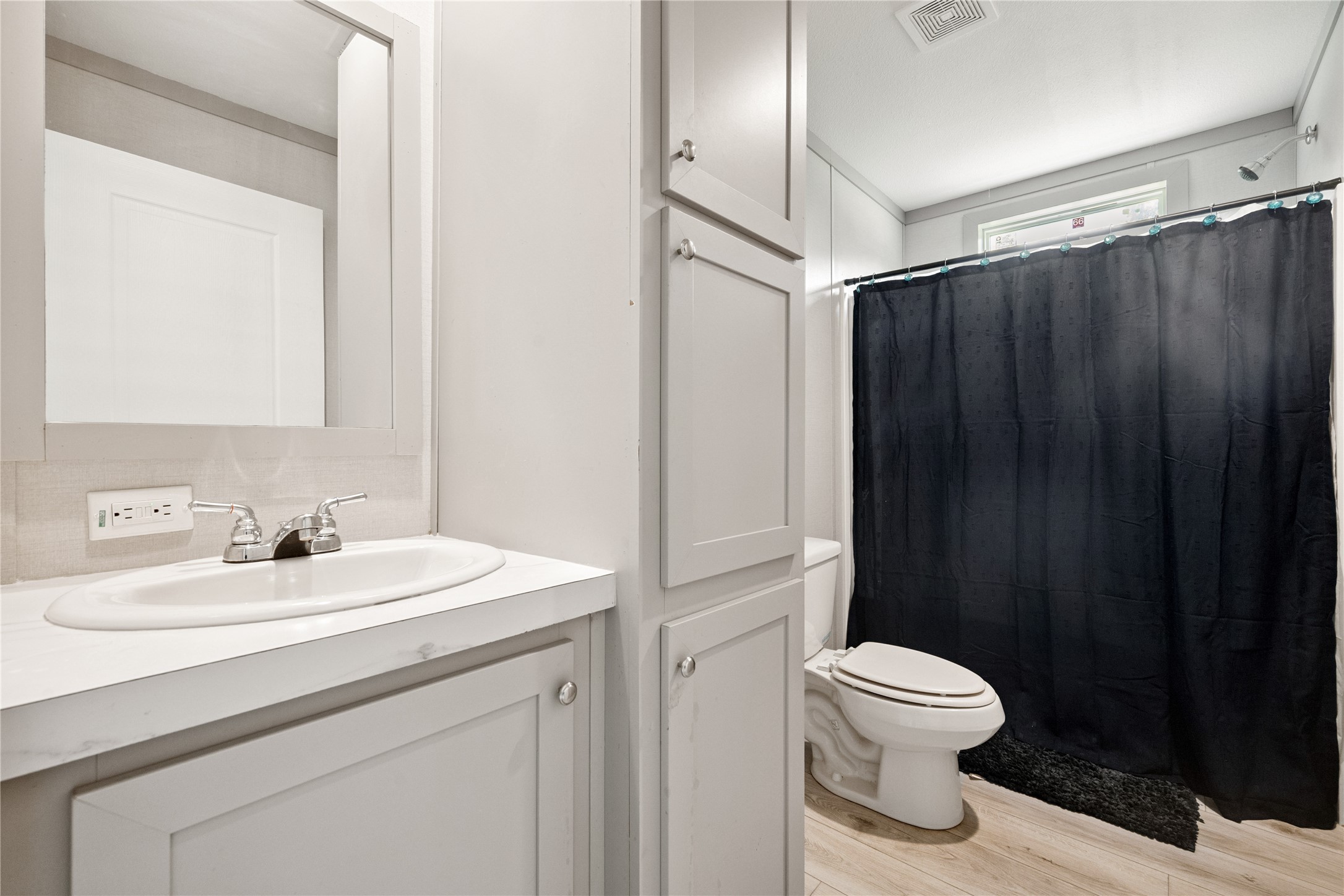 3006 County Road 2068 Hull, TX 77564 - Photo 24 of 27 a bathroom with a sink a toilet and a mirror
