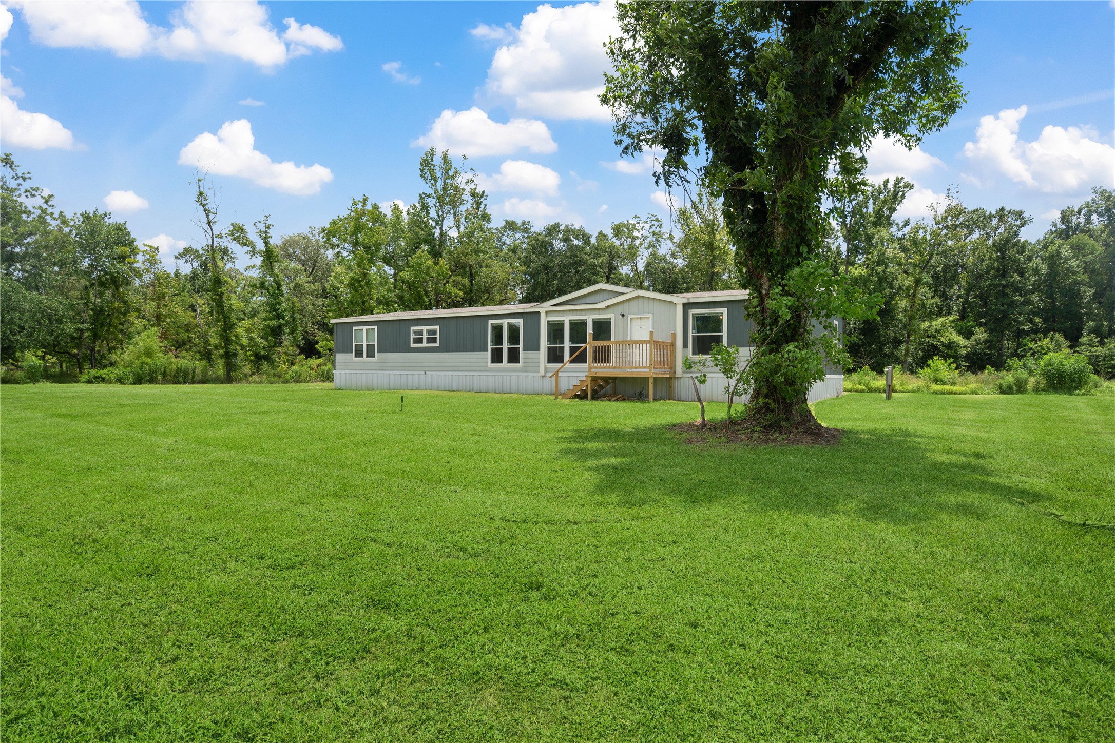 3006 County Road 2068 Hull, TX 77564 - Photo 4 of 27 a view of a house with a big yard