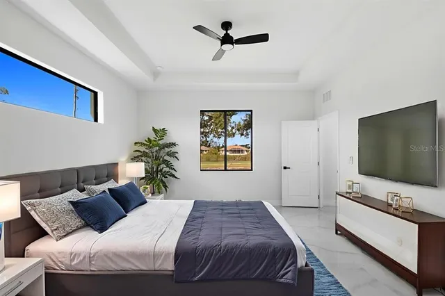 a bedroom with a bed and a flat screen tv