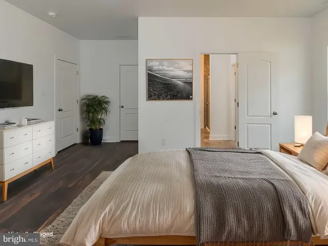 a bedroom with a bed and a flat screen tv