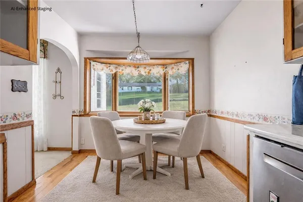 a dining room with furniture a chandelier and wooden floor