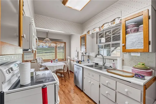 a kitchen with sink stove and cabinets