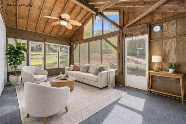 a living room with furniture and a large window