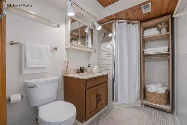 a bathroom with a sink toilet and shower