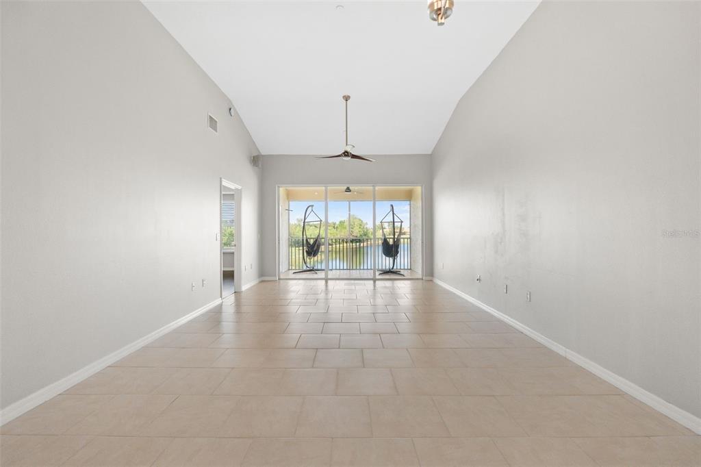 7187 Boca Grove Place, Unit 201 Lakewood Ranch, FL 34202 - Photo 14 of 48 wooden floor in an empty room with a window