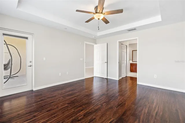 a bathroom with a granite countertop sink mirror and a toilet