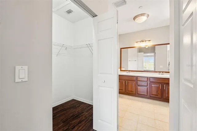 a bathroom with a double vanity sink mirror and shower