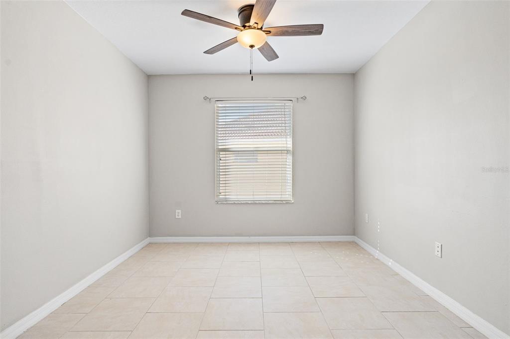 7187 Boca Grove Place, Unit 201 Lakewood Ranch, FL 34202 - Photo 22 of 48 an empty room with a window and a fan