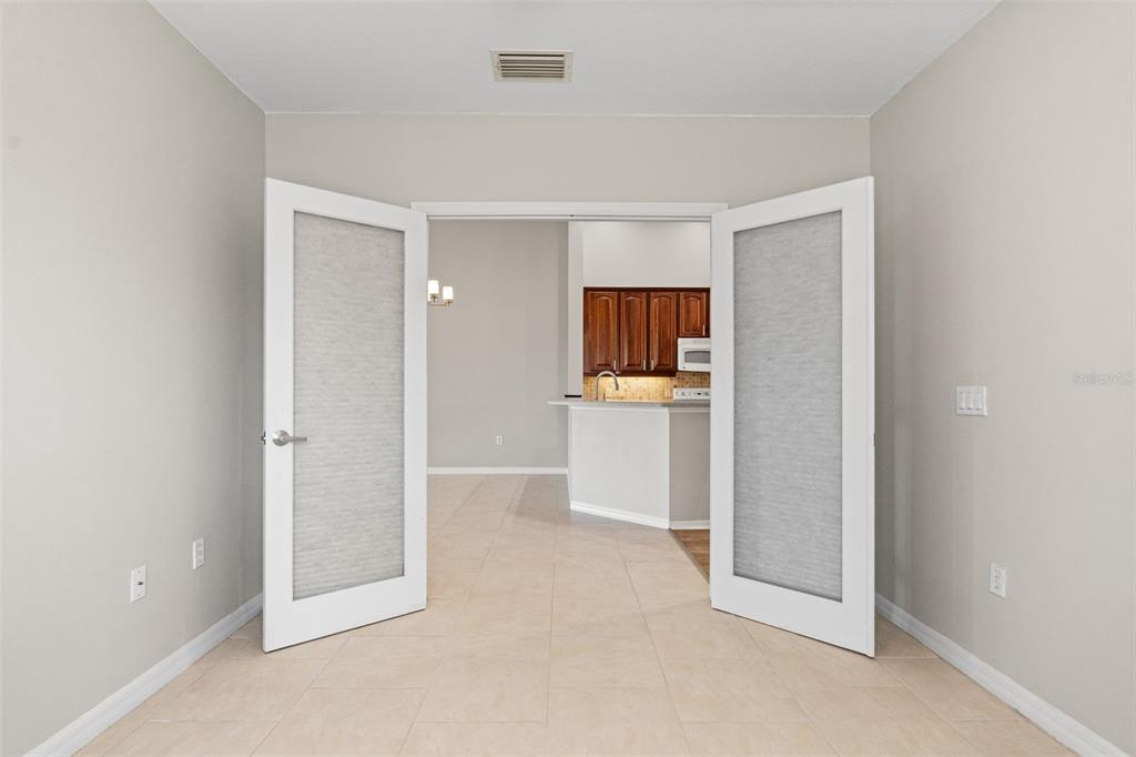7187 Boca Grove Place, Unit 201 Lakewood Ranch, FL 34202 - Photo 23 of 48 a view of a kitchen with a sink and cabinets