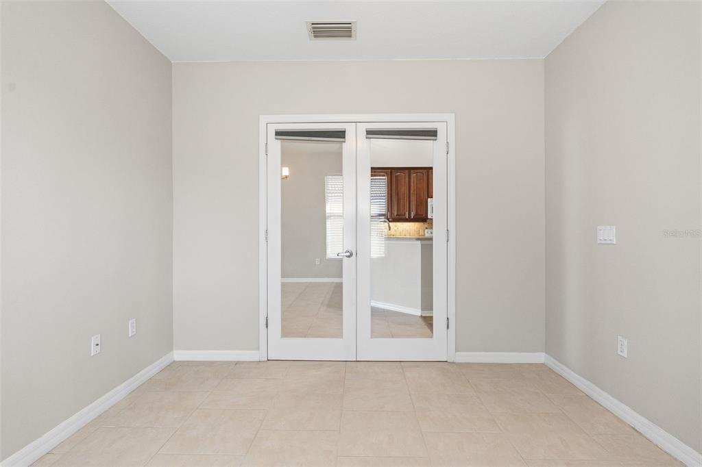 7187 Boca Grove Place, Unit 201 Lakewood Ranch, FL 34202 - Photo 24 of 48 an empty room with mirror in it