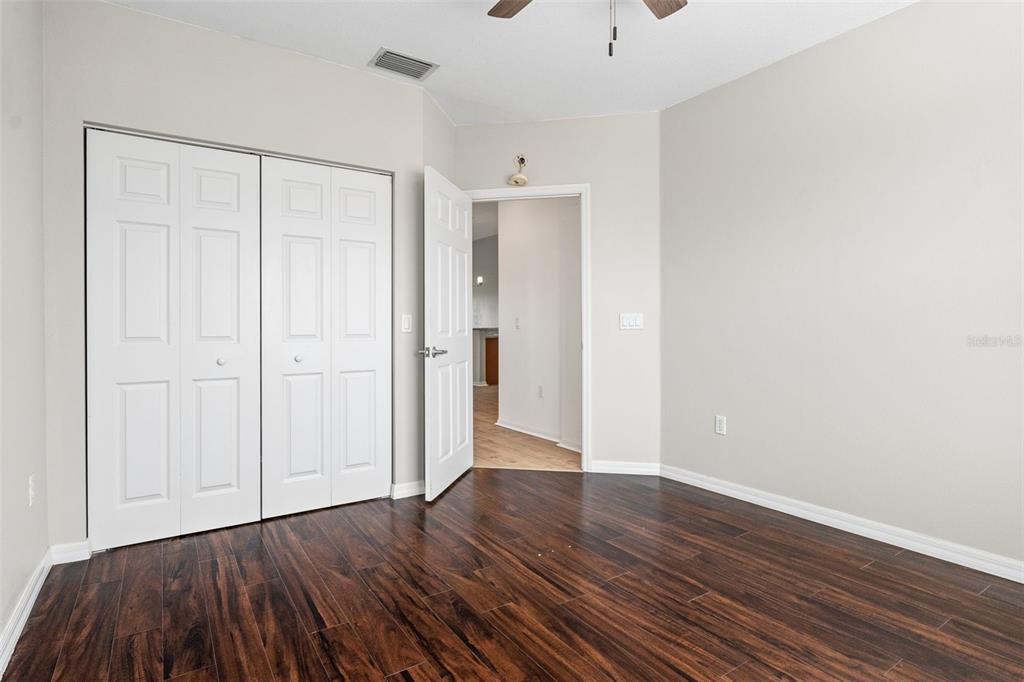 7187 Boca Grove Place, Unit 201 Lakewood Ranch, FL 34202 - Photo 26 of 48 a view of an empty room with wooden floor