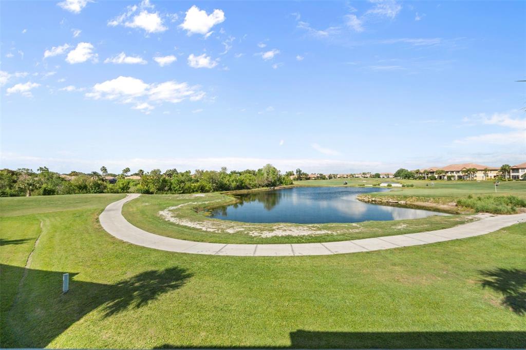 7187 Boca Grove Place, Unit 201 Lakewood Ranch, FL 34202 - Photo 31 of 48 a view of a lake with a big yard