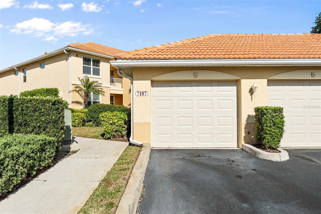 7187 Boca Grove Place, Unit 201 Lakewood Ranch, FL 34202 - Photo 32 of 48 a view of a house with a garage