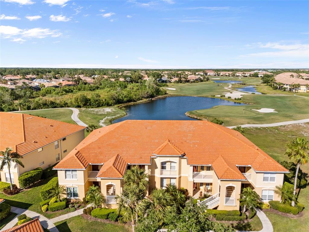 7187 Boca Grove Place, Unit 201 Lakewood Ranch, FL 34202 - Photo 35 of 48 an aerial view of a house with a lake view