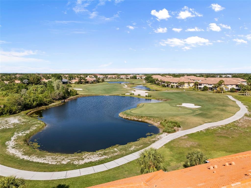 7187 Boca Grove Place, Unit 201 Lakewood Ranch, FL 34202 - Photo 36 of 48 a view of a lake with a yard