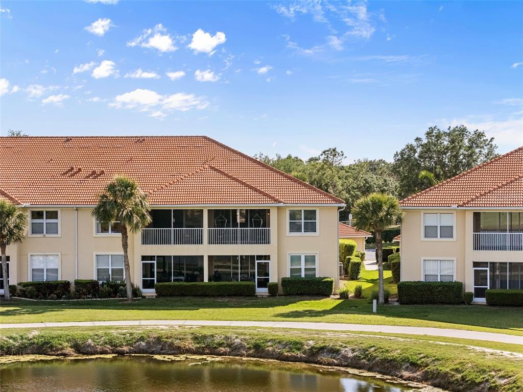 7187 Boca Grove Place, Unit 201 Lakewood Ranch, FL 34202 - Photo 37 of 48 a front view of a house with a yard
