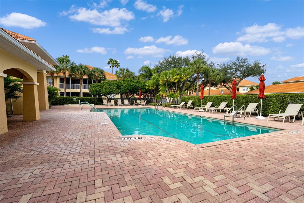 7187 Boca Grove Place, Unit 201 Lakewood Ranch, FL 34202 - Photo 41 of 48 a view of a swimming pool and a yard