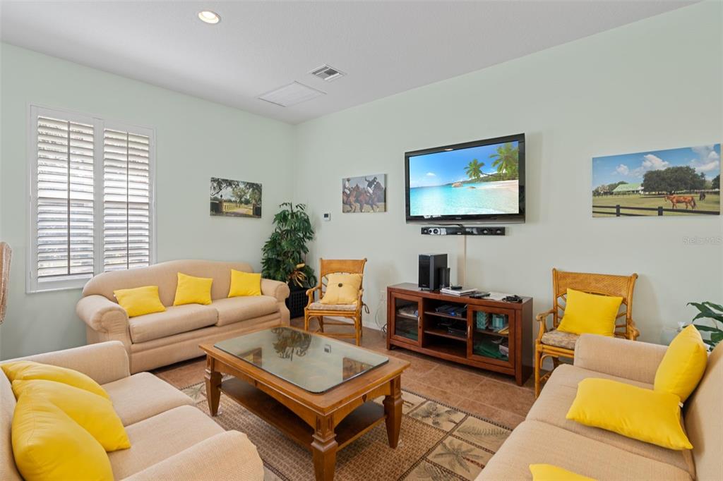 7187 Boca Grove Place, Unit 201 Lakewood Ranch, FL 34202 - Photo 44 of 48 a living room with furniture a rug and a window