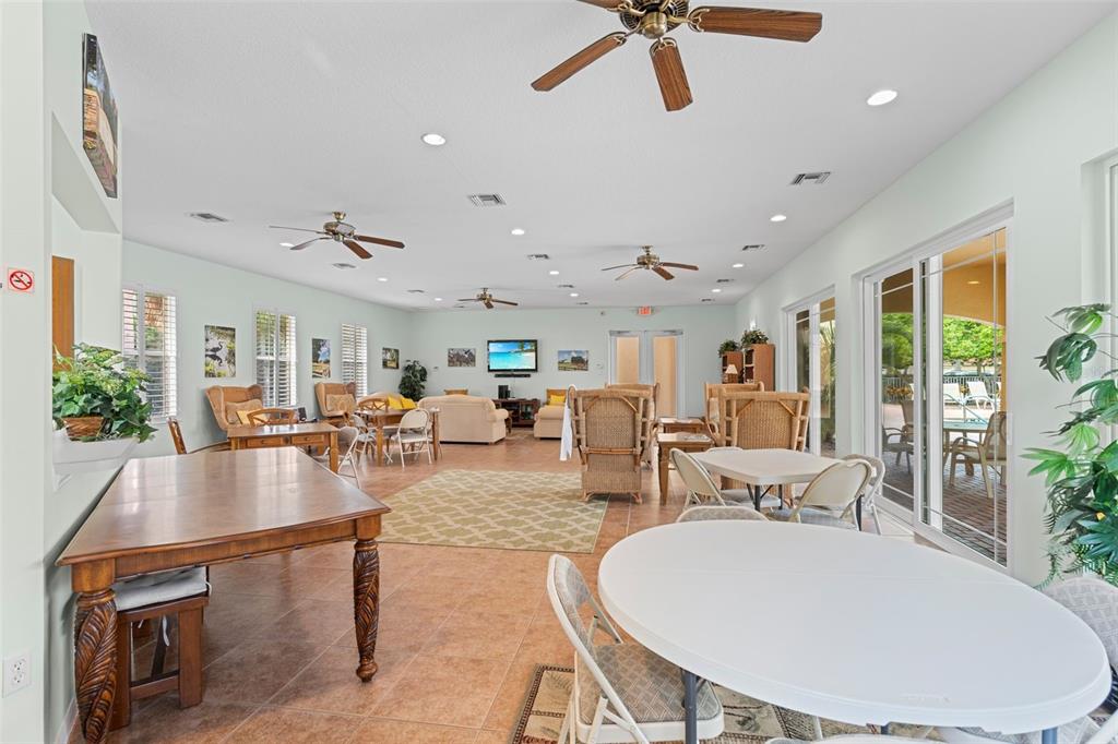 7187 Boca Grove Place, Unit 201 Lakewood Ranch, FL 34202 - Photo 45 of 48 a living room with furniture a rug and a chandelier