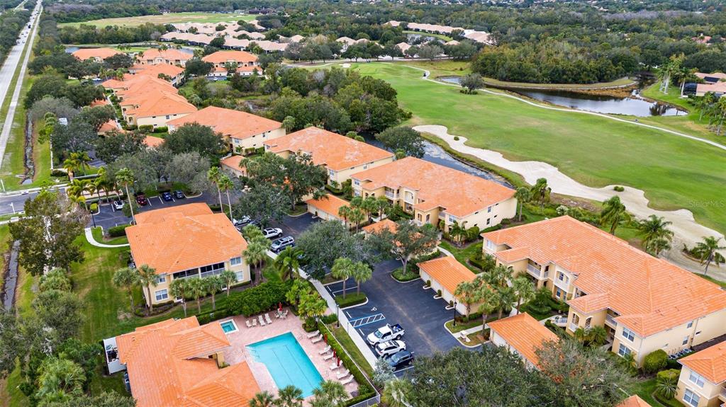 7187 Boca Grove Place, Unit 201 Lakewood Ranch, FL 34202 - Photo 48 of 48 an aerial view of a house with a garden and lake view