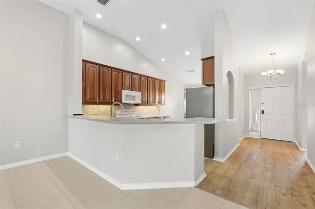 a kitchen with stainless steel appliances a refrigerator and a stove top oven