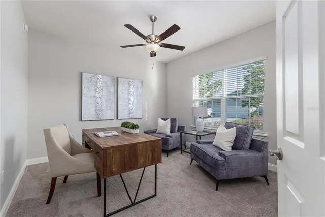 a bedroom with a bed and a lamp on dresser